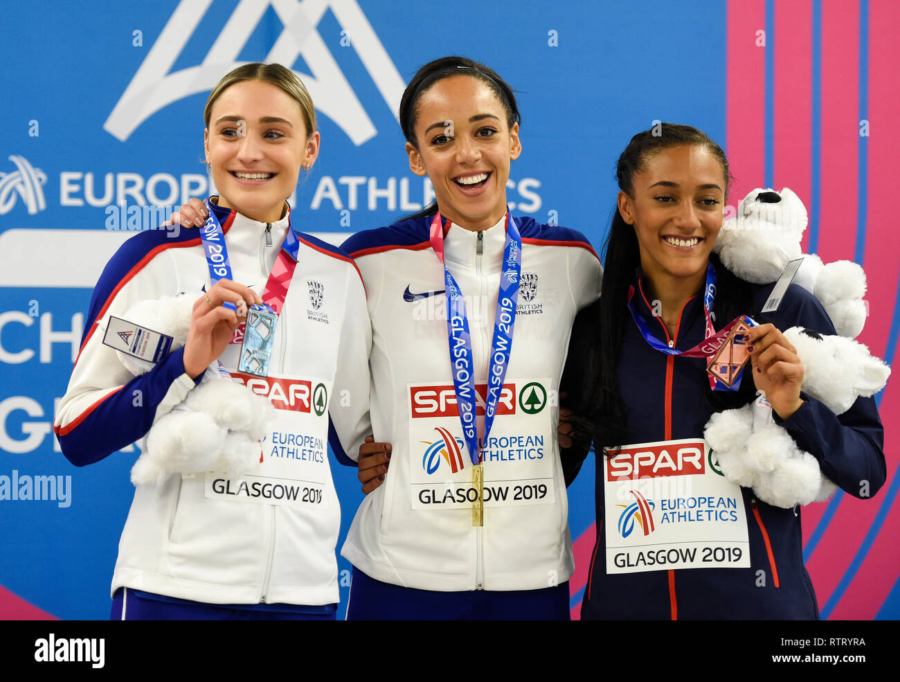 Great Britain's Niamh Emerson, (Silver) and Katarina Johnson-Thompson (gold) and France's Solene Ndama (bronze) after the Women's Pentathlon medal ceremony during day two of the European Indoor Athletics Championships at the Emirates Arena, Glasgow. Stock Photo