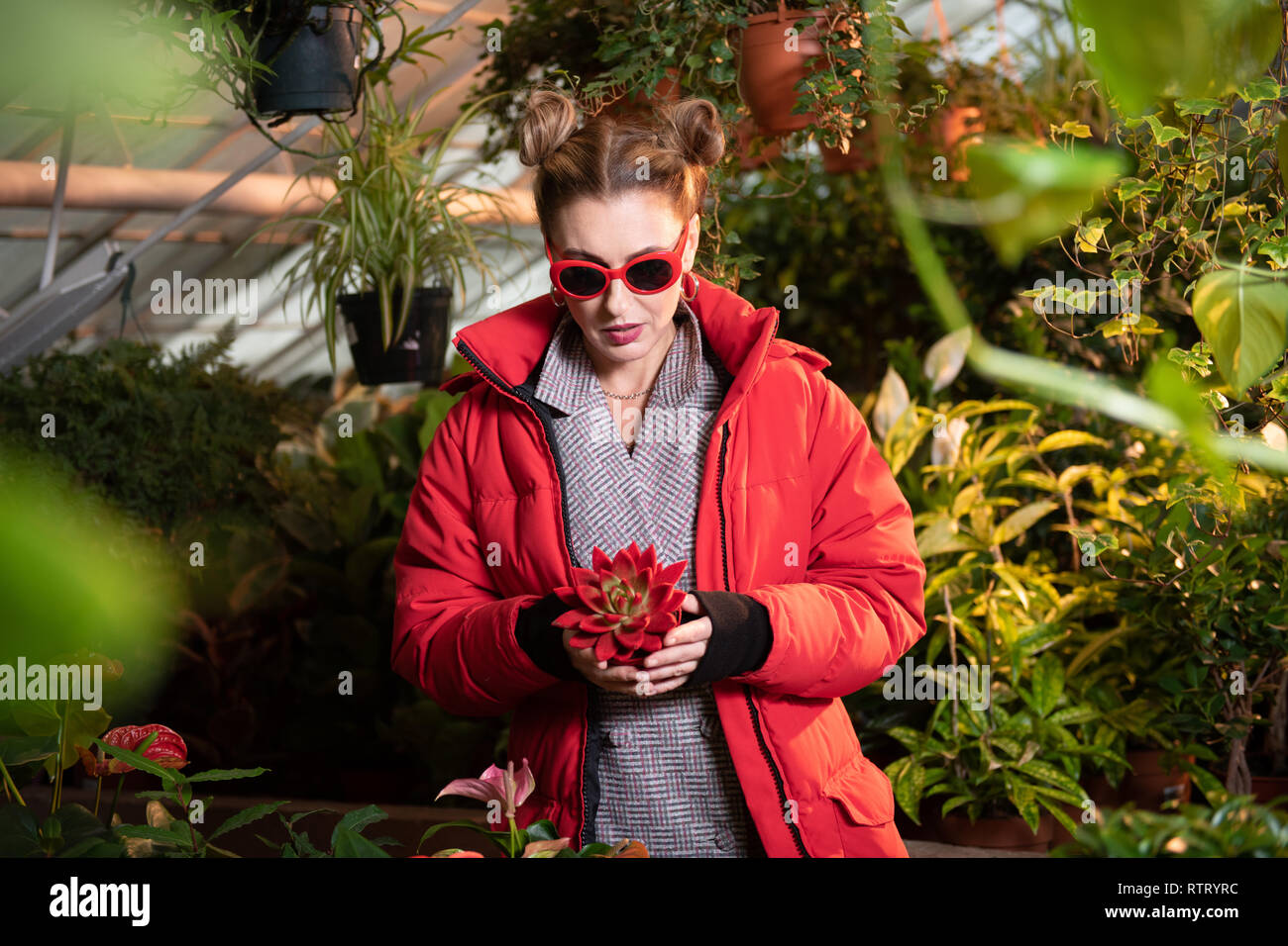 Beautiful pretty woman holding a beautiful red flower Stock Photo