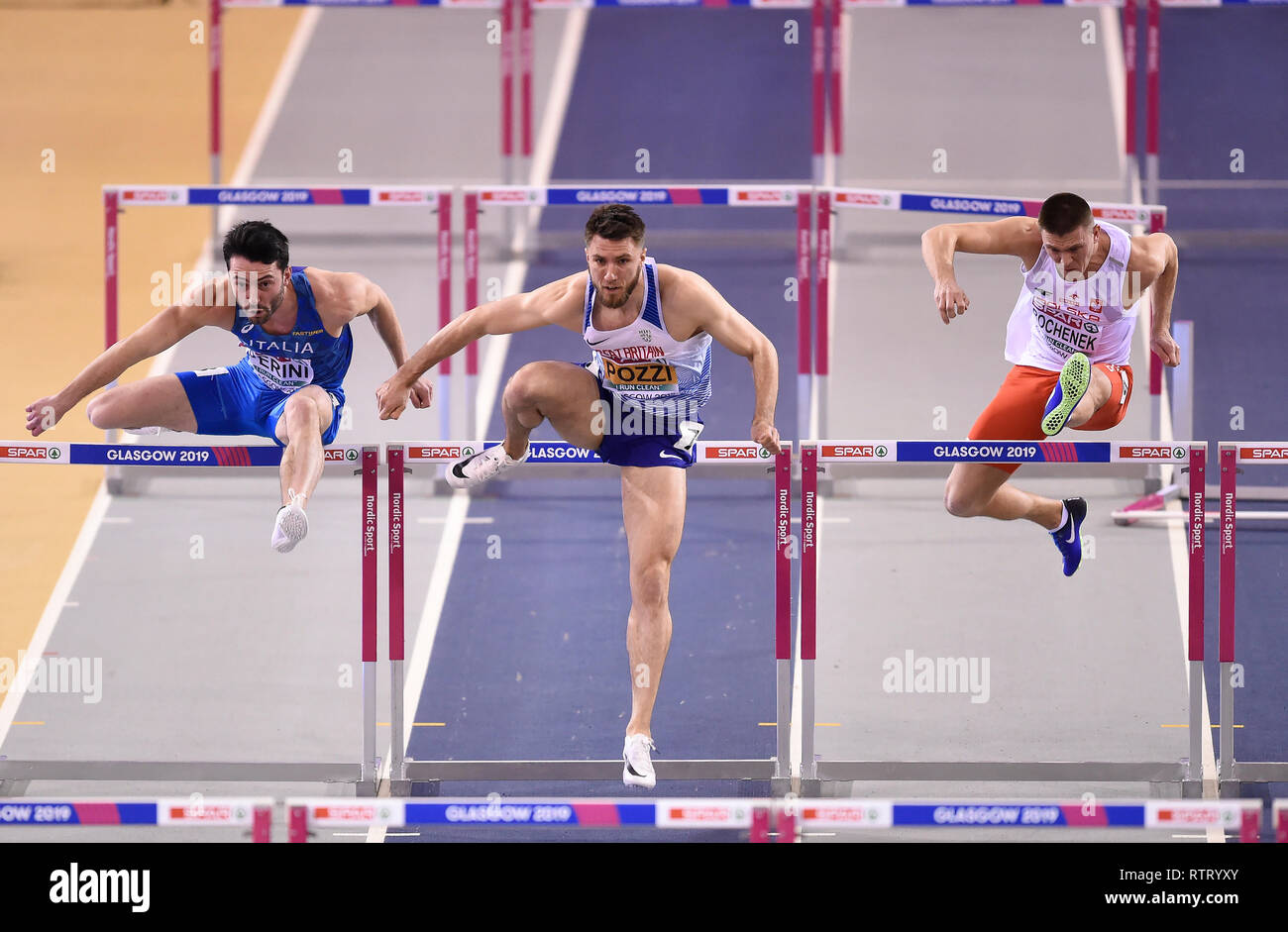 Great Britain's Andy Pozzi (centre) Italy's Lorenzo Perini and Poland's Dominik Bochenek competing in Heat 1 of the Men's 60m hurdles event during day two of the European Indoor Athletics Championships at the Emirates Arena, Glasgow. Stock Photo