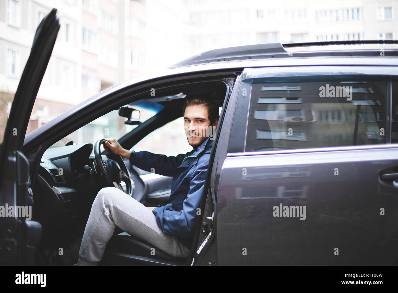 businessman sitting behind the wheel of a car Stock Photo - Alamy