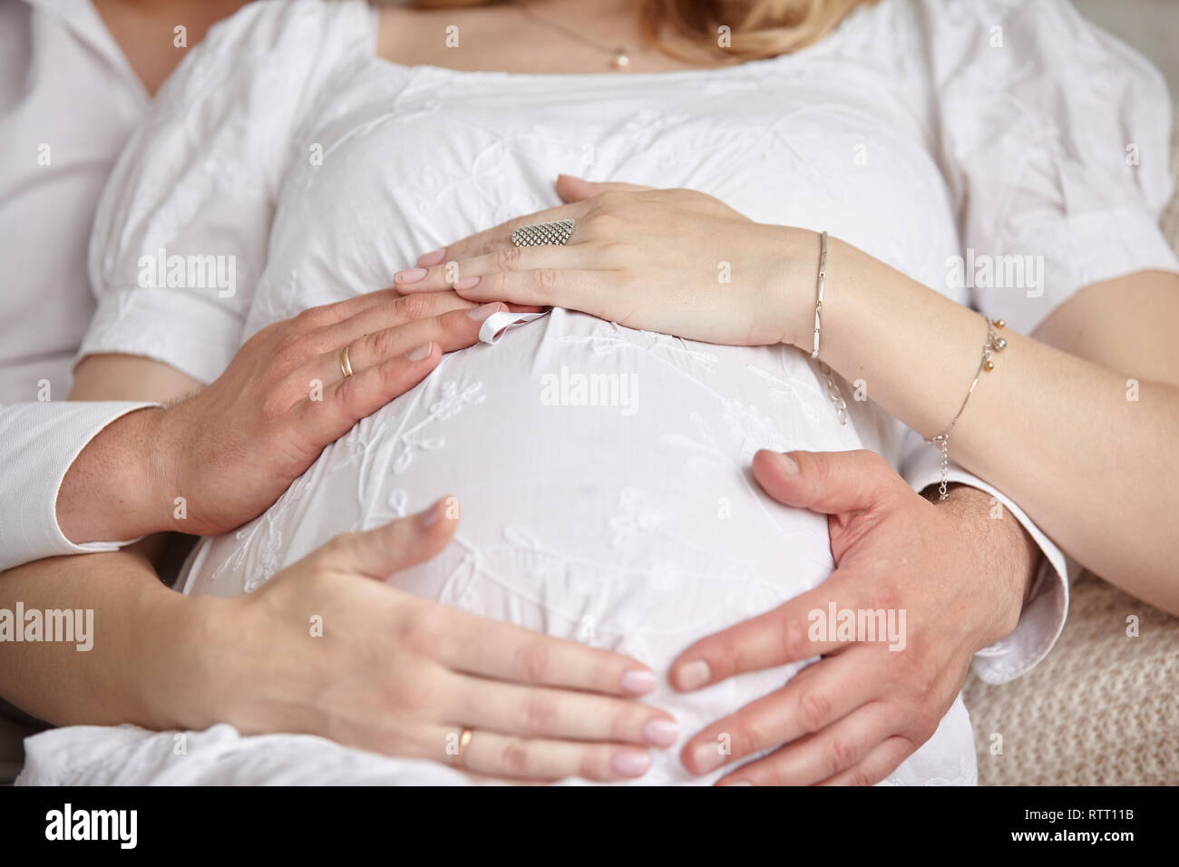 close up. man hugging his pregnant wife Stock Photo - Alamy