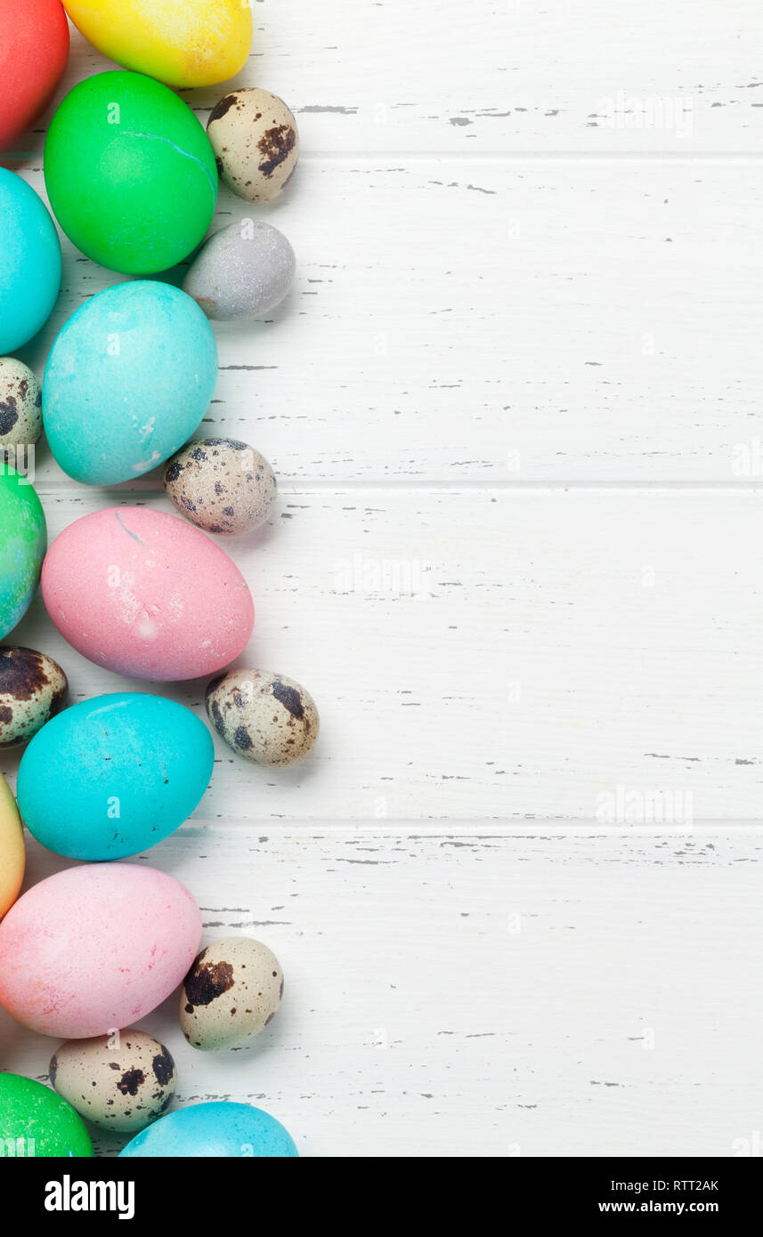 Easter greeting card with colorful easter eggs. Top view on wooden ...