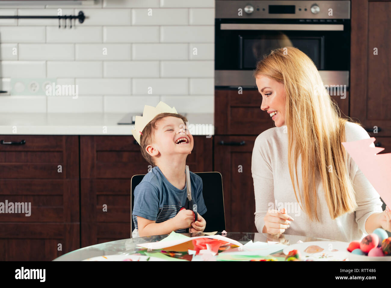 Joyful little boy of 4 years-old learning how to use scissors together ...