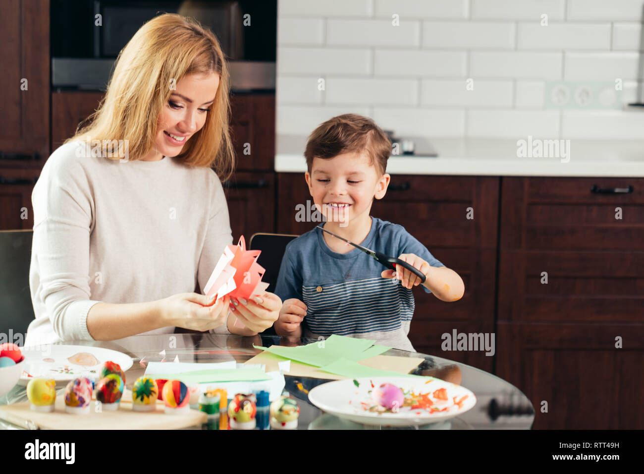 Joyful little boy of 4 years-old learning how to use scissors together ...