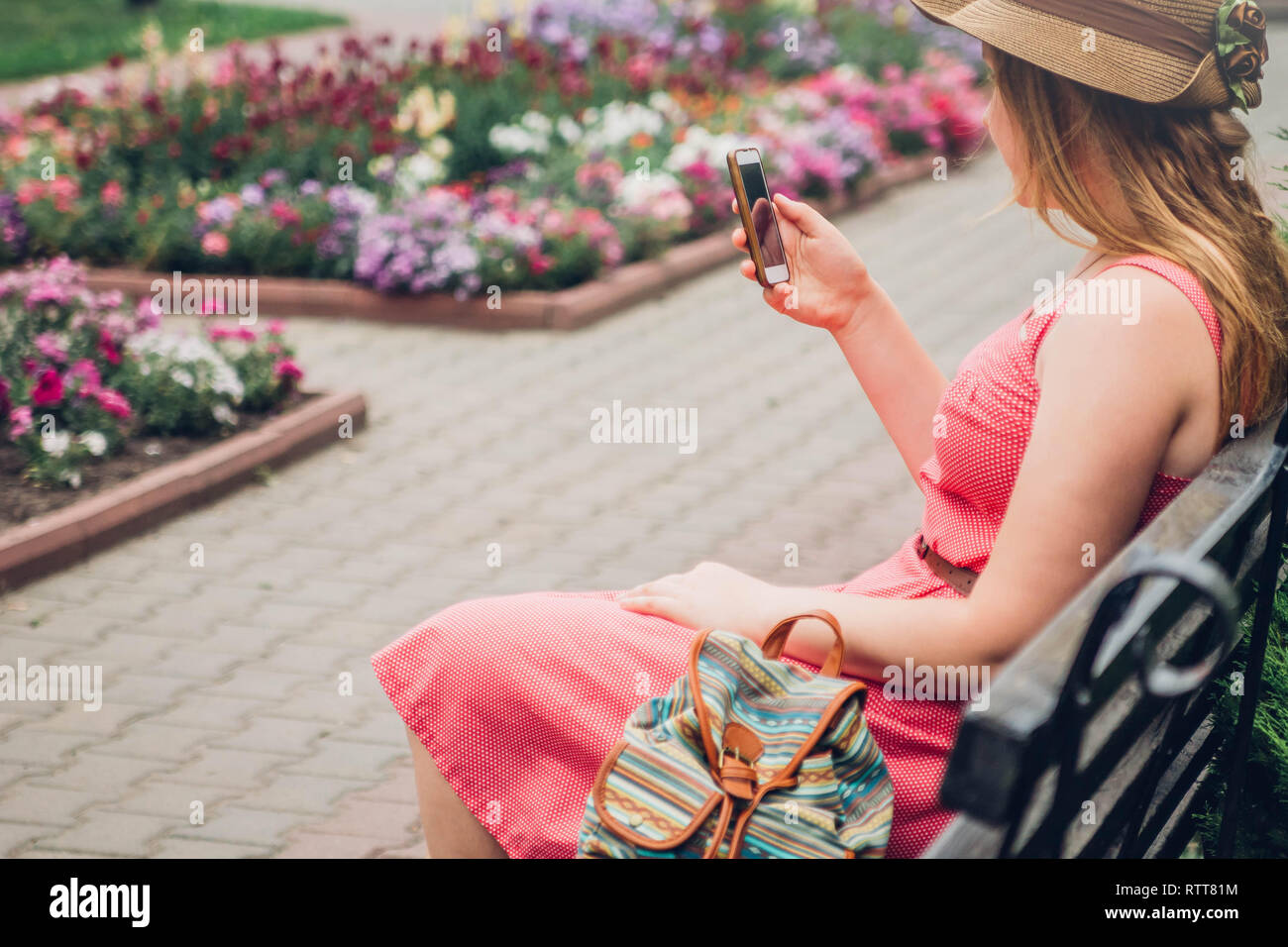 Girl sitting on bench backpack hi-res stock photography and images - Alamy
