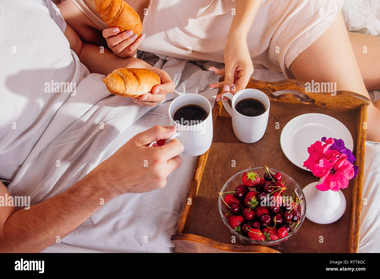 Couple in love having breakfast in bed Stock Photo - Alamy