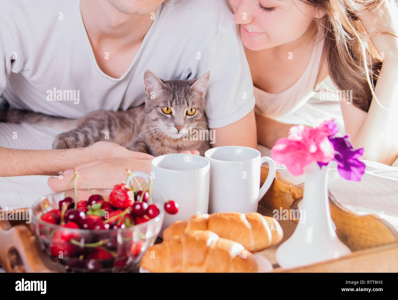 Couple in love having breakfast in bed Stock Photo