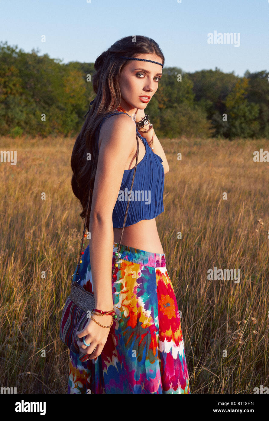 Outdoor portrait of the beautiful young boho (hippie) girl in field at ...