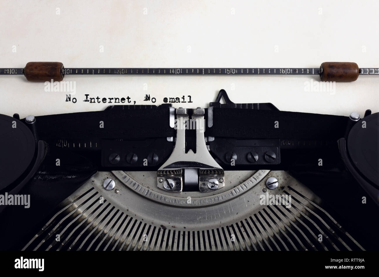 Old retro vintage black typewriter with close-up typing text No Internet, No email as heading on aged paper, blackout concept Stock Photo