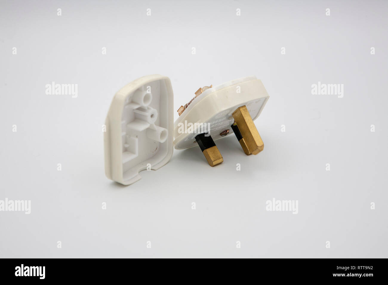 A UK Standard 3 PIN Plug with 13amp fuse, and the rear protective panel removed. Stock Photo