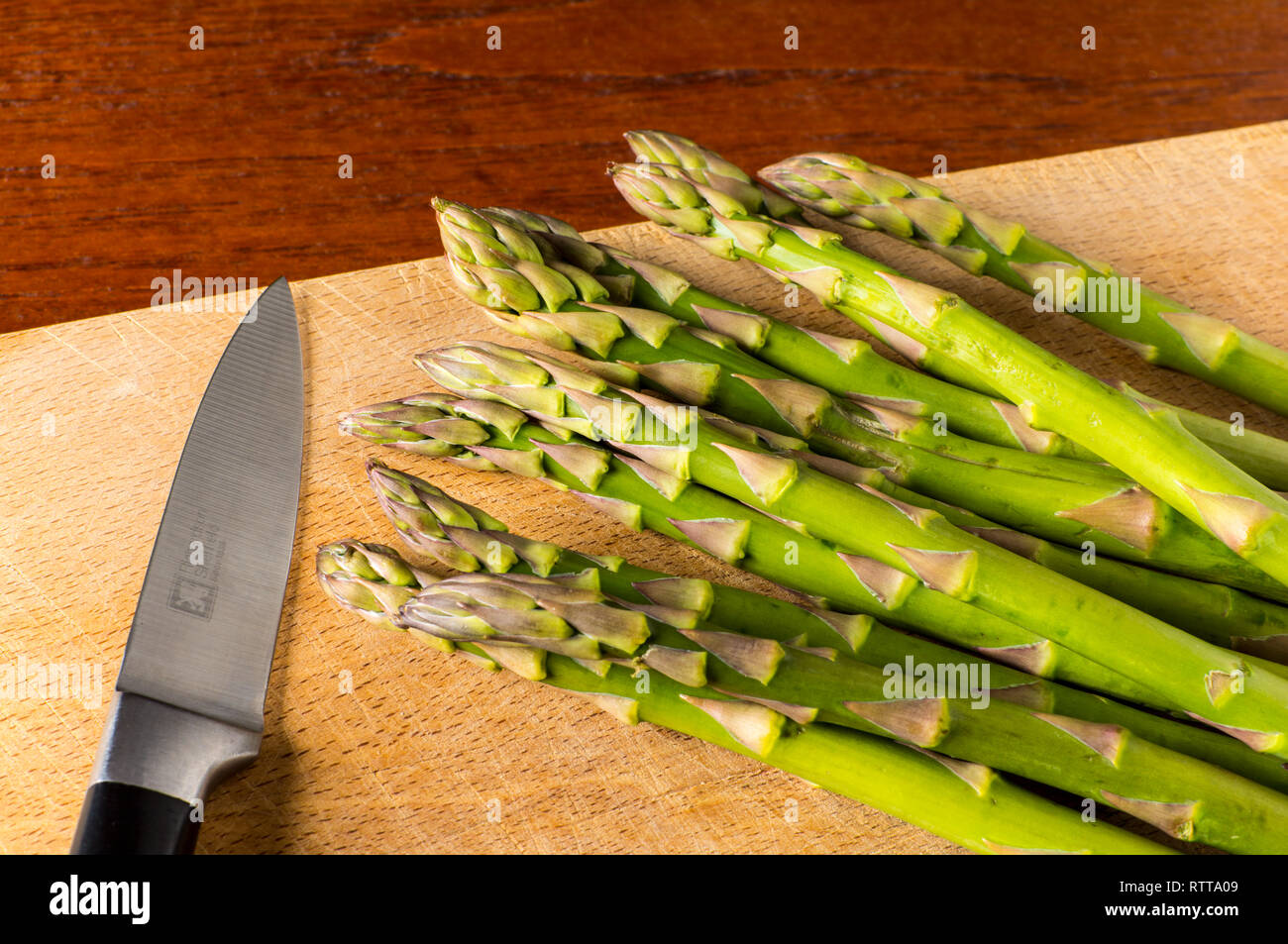 Asparagus tips with knife Stock Photo Alamy