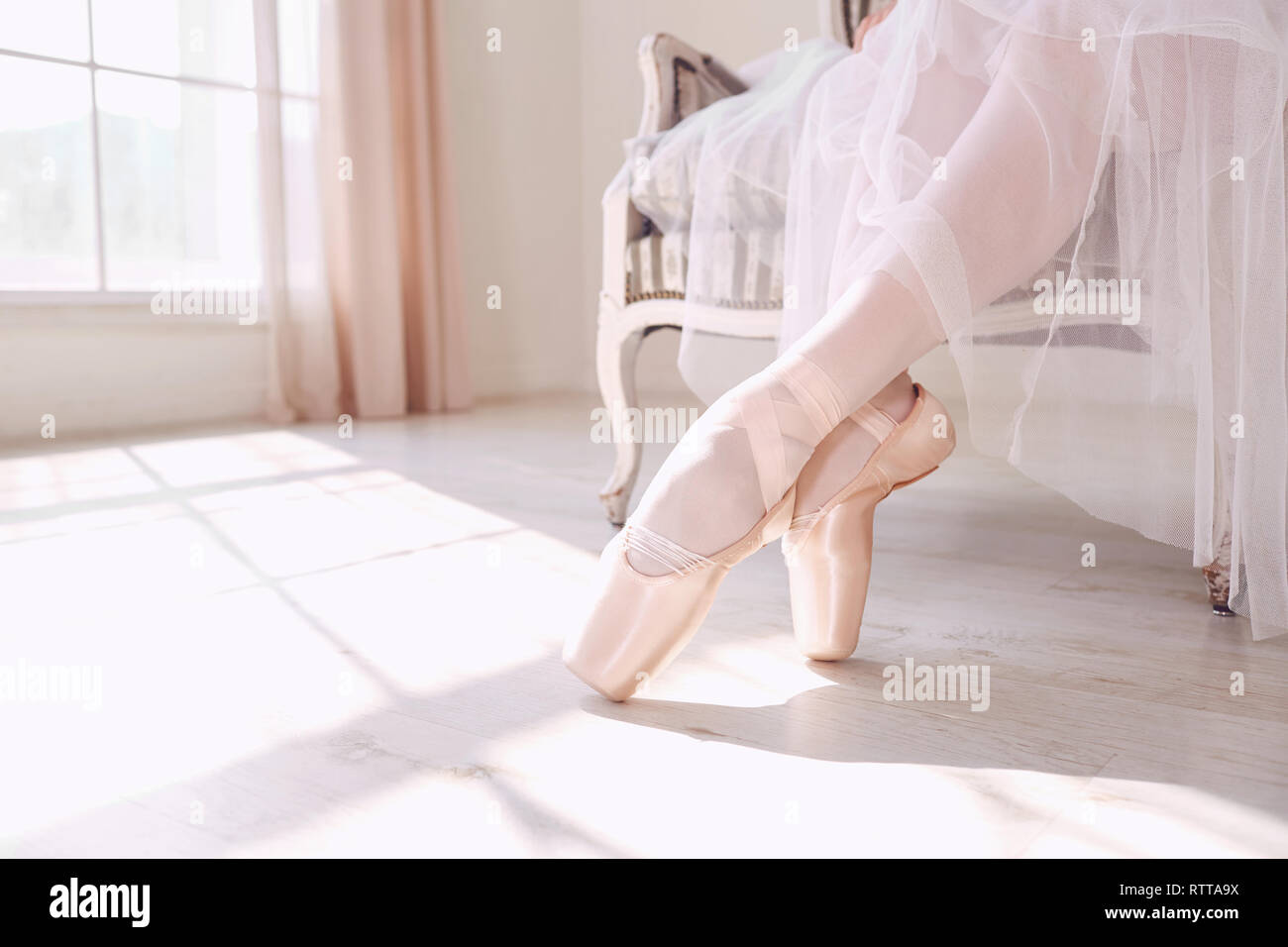 Pointe shoes on the feet of a ballerina. Stock Photo