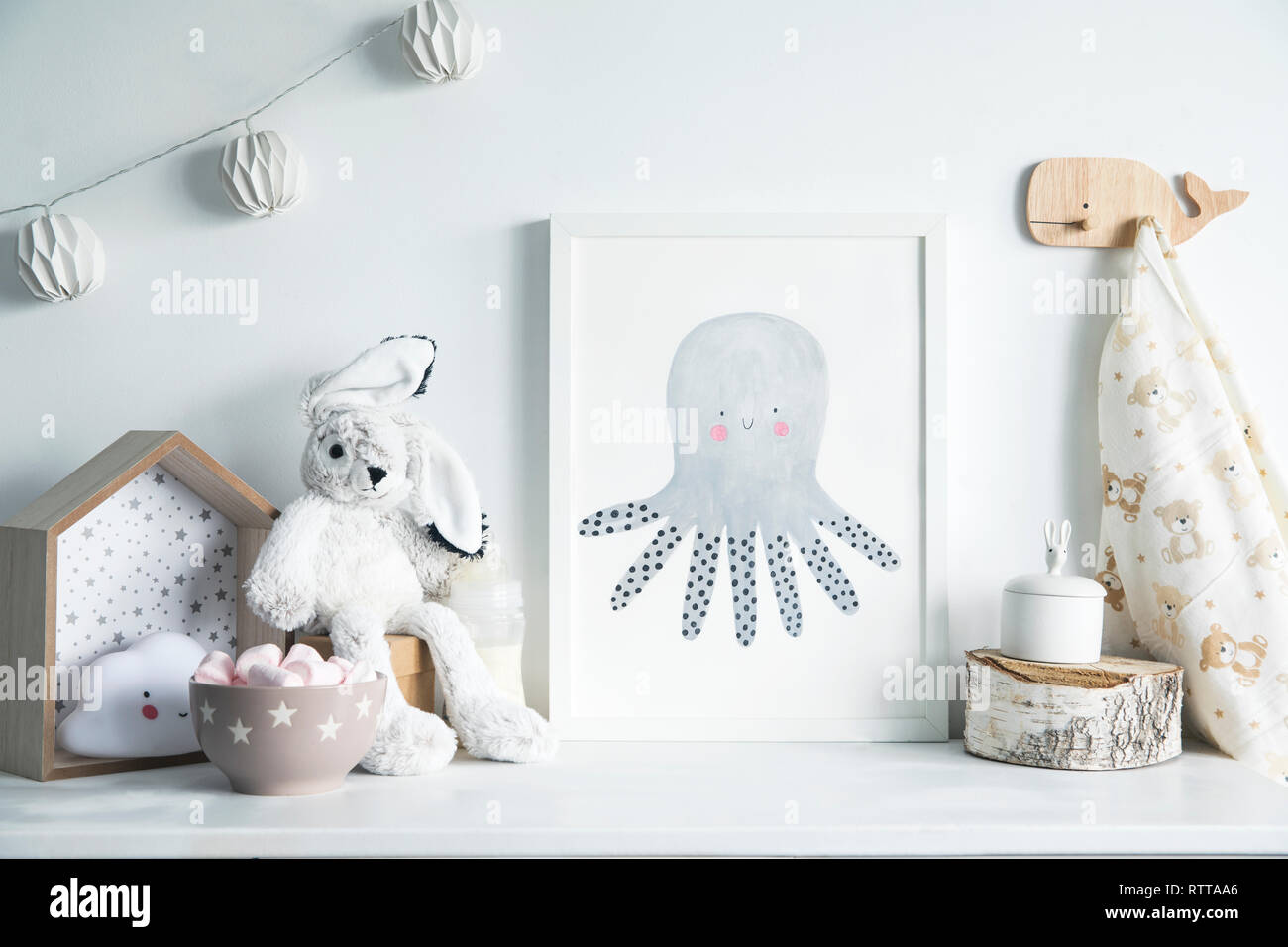 Modern nursery interior with white walls, wooden accessories and toys