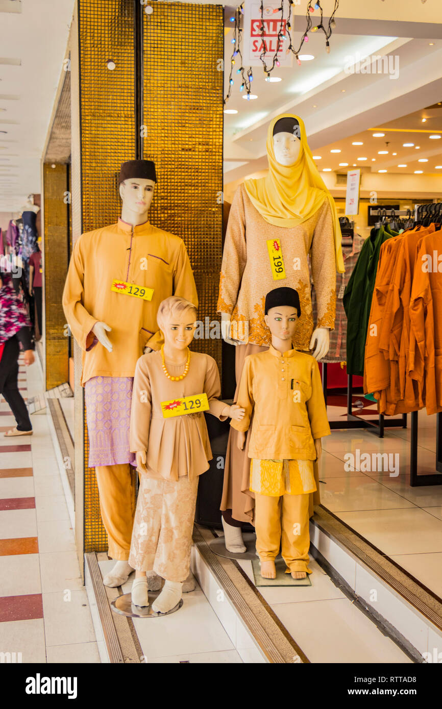 store display of mannequins of family group wearing traditional indian