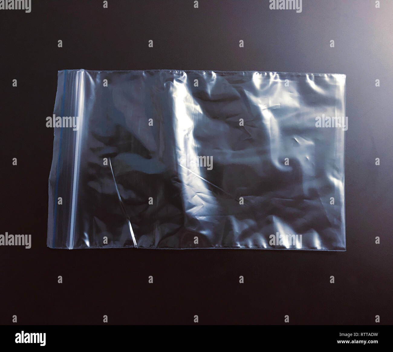 Transparent polyethylene package bag on dark background Stock Photo