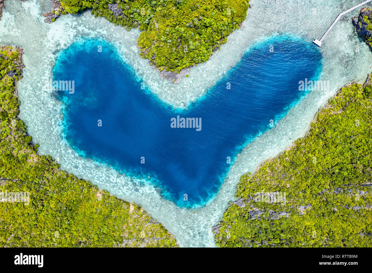 aerial view of a remote set of limestone islands with a heart-shaped, natural lagoon, Raja Ampat Islands, West Papua, Indonesia, Pacific Ocean Stock Photo