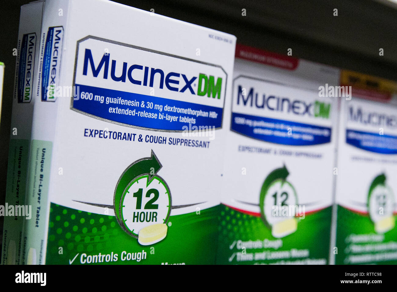 Mucinex DM over-the-counter cold medicine photographed in a pharmacy. Stock Photo