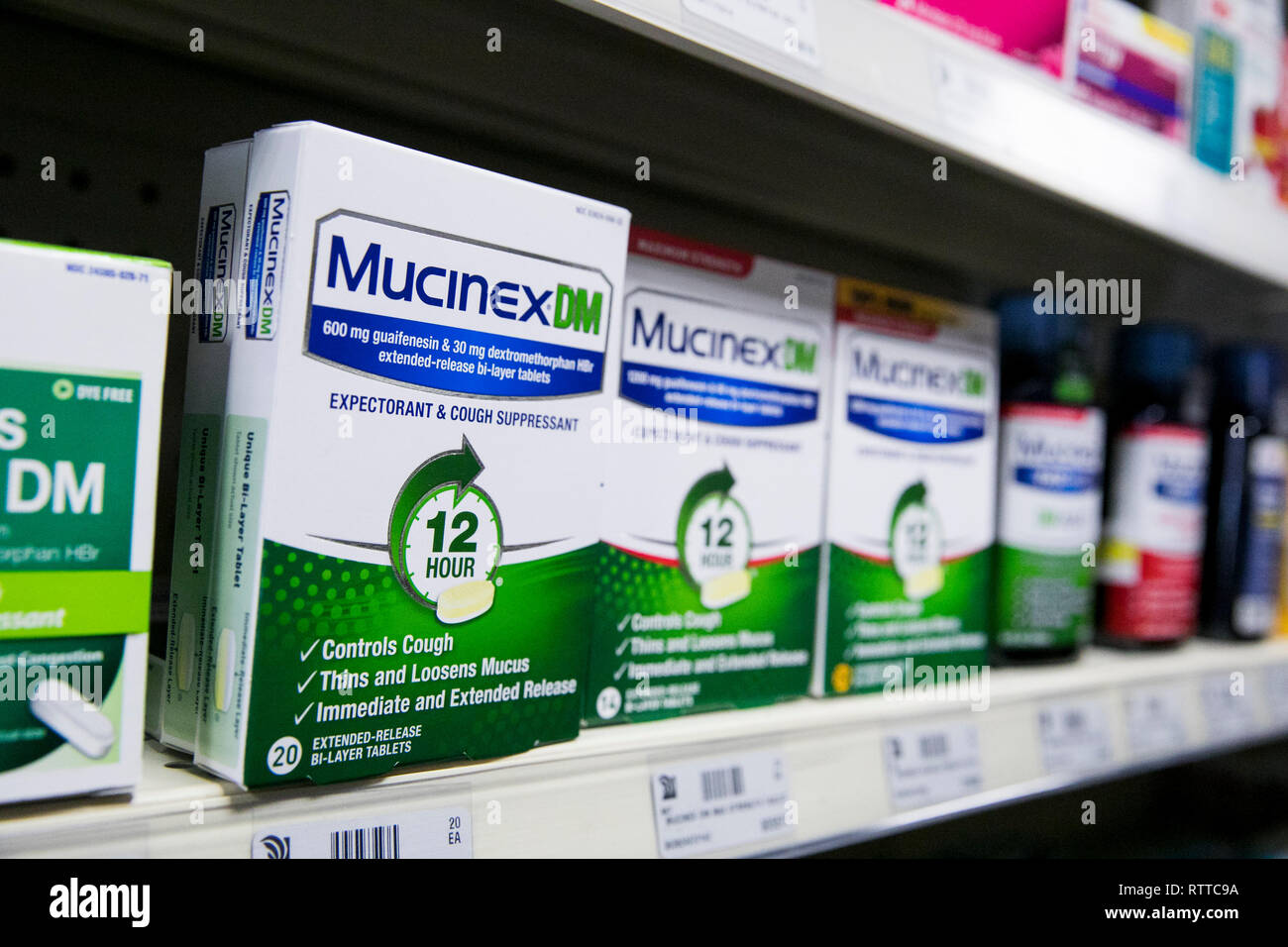 Mucinex DM over-the-counter cold medicine photographed in a pharmacy. Stock Photo