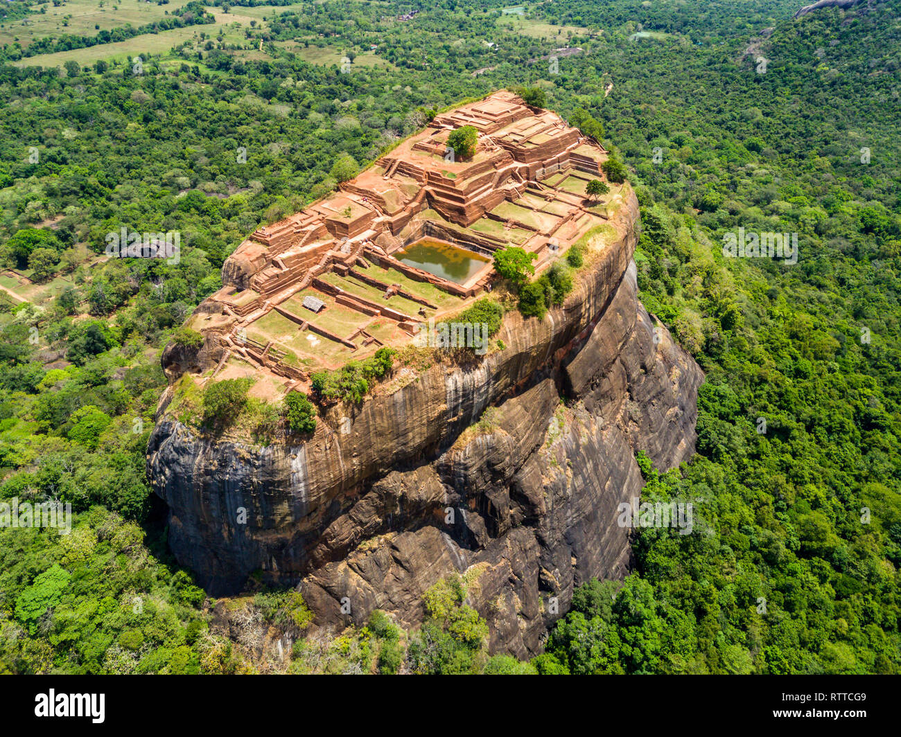 Sigiriya or the Lion Rock, an ancient fortress and a palace with gardens, pools, and terraces atop of granite rock in Dambulla, Sri Lanka. Aerial view. Stock Photo