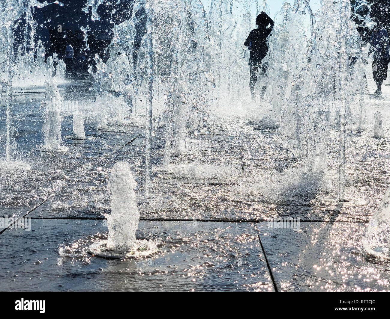 Child Is Playing In Dry Fountain On Hot Sunny Day Stock Photo