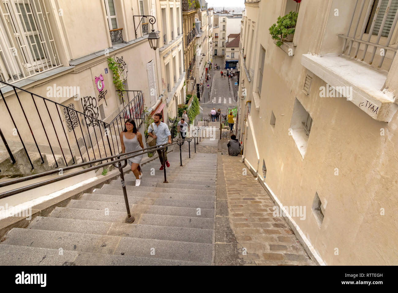 People climbing the steep steps at Rue Drevet , in Montmartre which