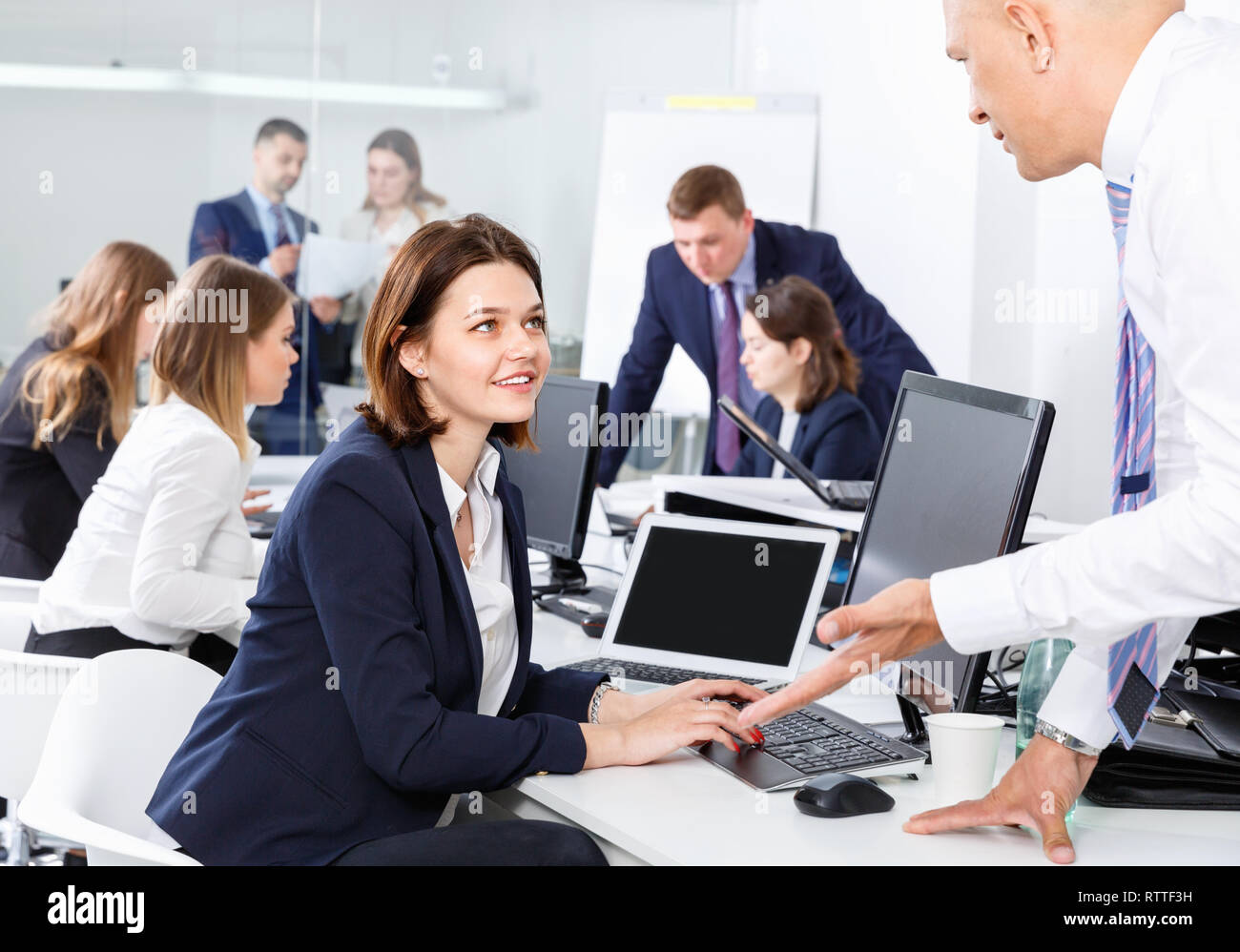 Friendly smiling cheerful coworkers having pleasant fun conversation at  workplace in modern office Stock Photo - Alamy, image size:1300x998