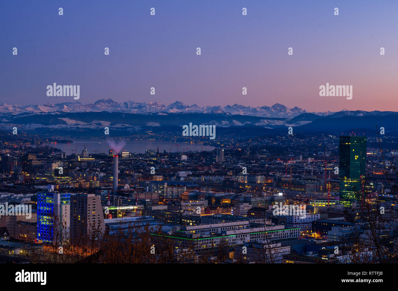 Zurich city overlook at sunset, blue hour alps in the background Stock Photo