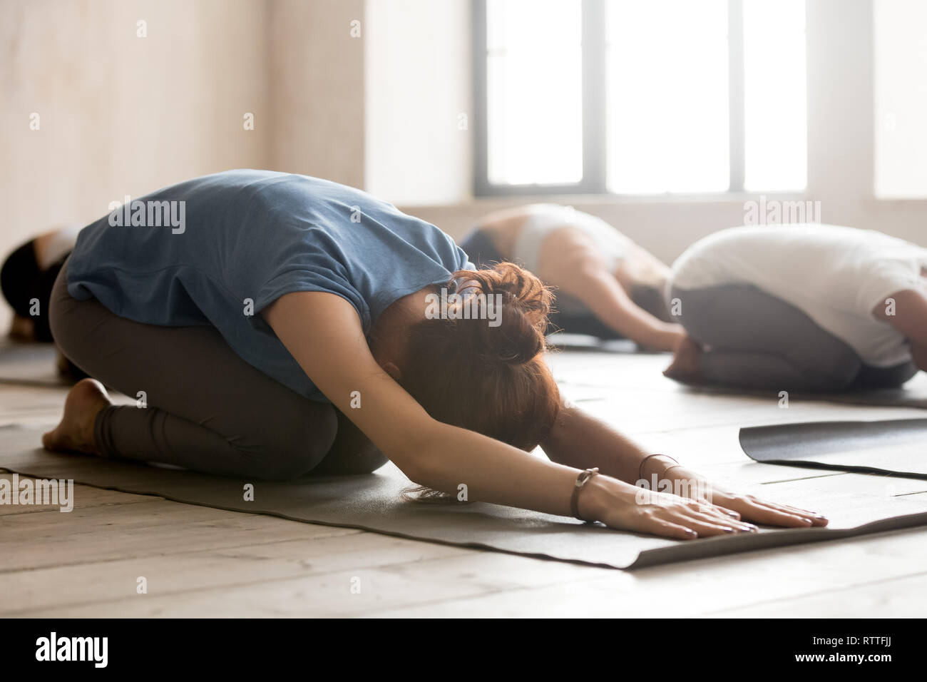 Group of people practicing yoga, doing Child pose, close up Stock Photo
