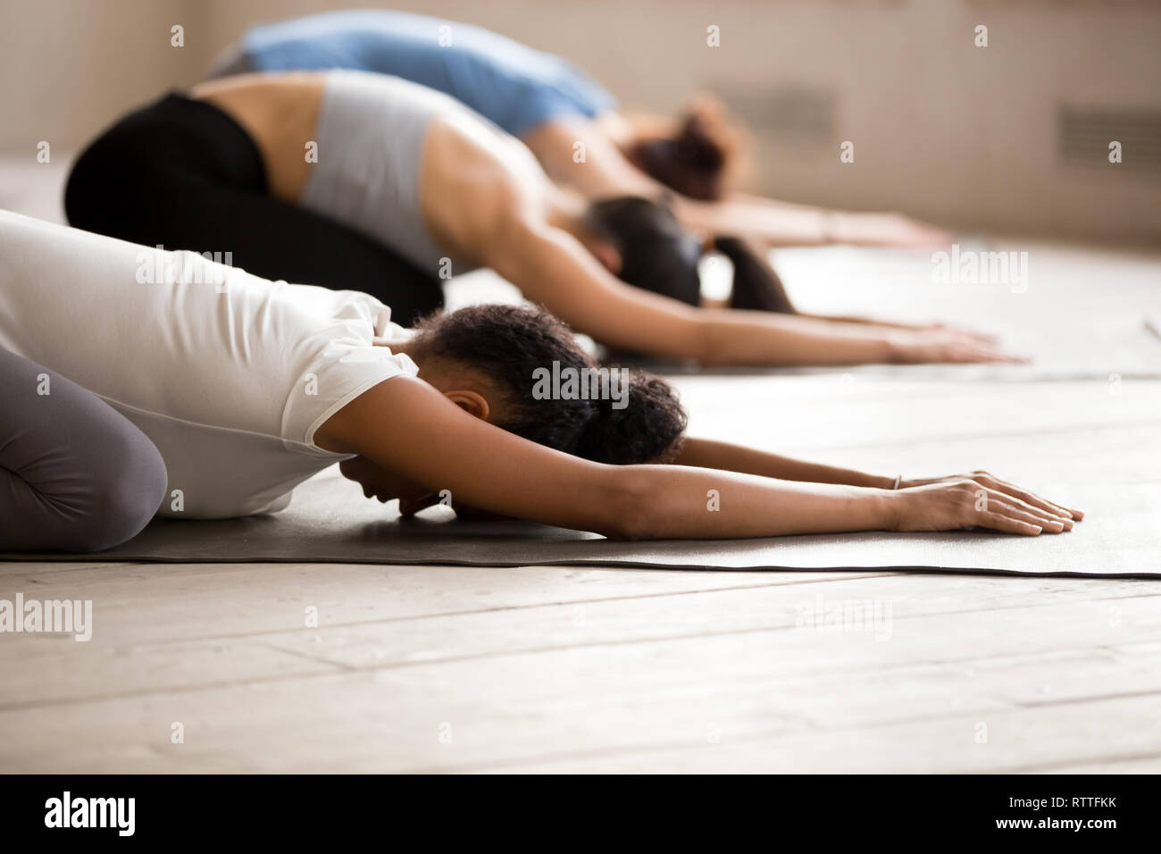 Group of women practicing yoga in Child pose Stock Photo