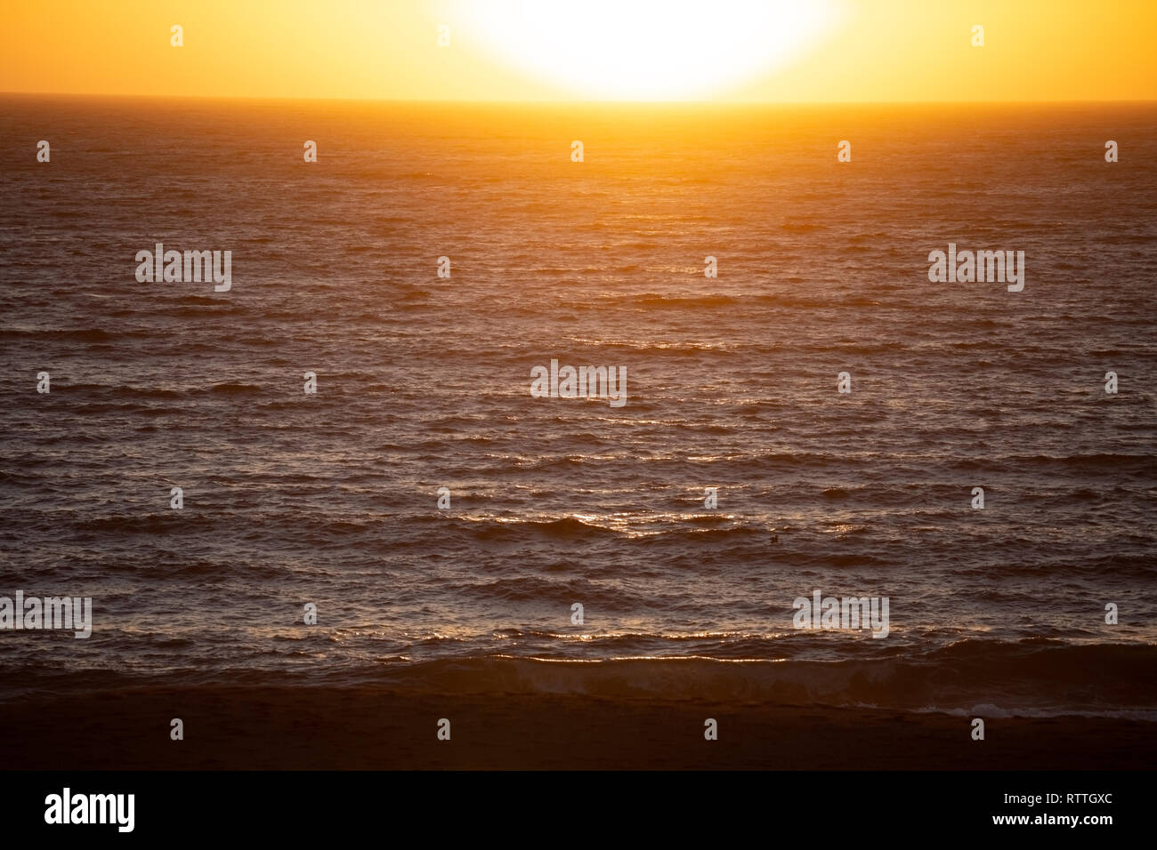 Waves lit by the setting sun over the Pacific Ocean, taken from Gualala, Mendocino County, California, America Stock Photo