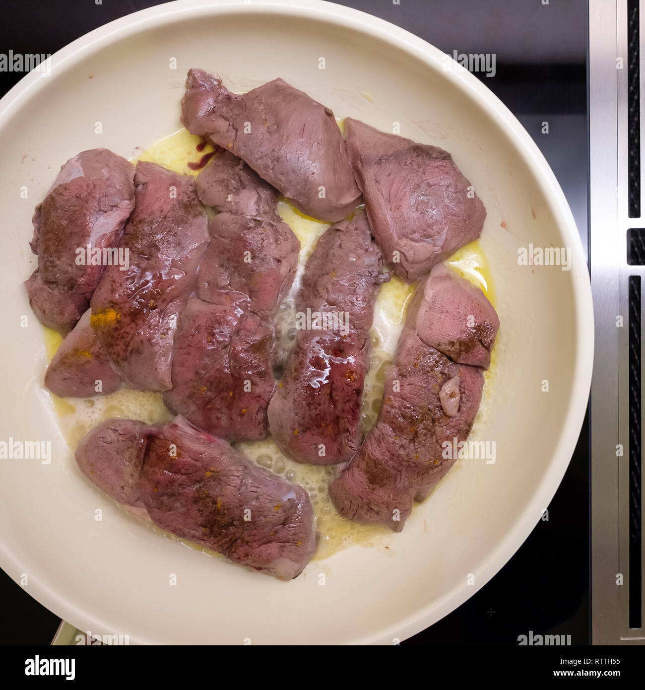 Venison meat is frying in a pan with butter Stock Photo Alamy