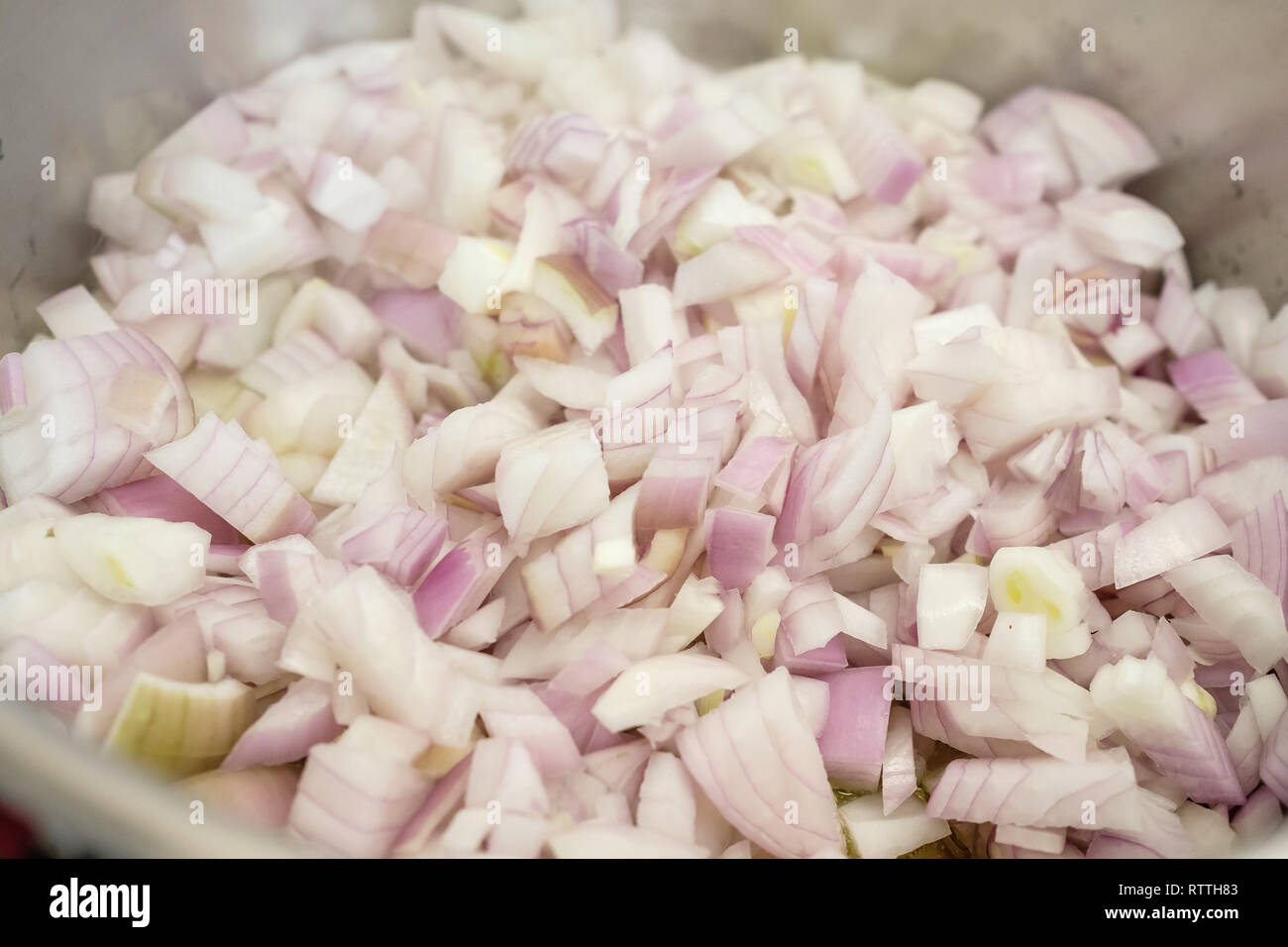 Little chopped onions sweating in a cooking pot Stock Photo Alamy