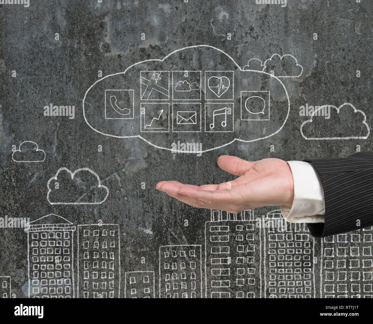 Man hand showing cloud with app icons doodles on mottled wall background Stock Photo