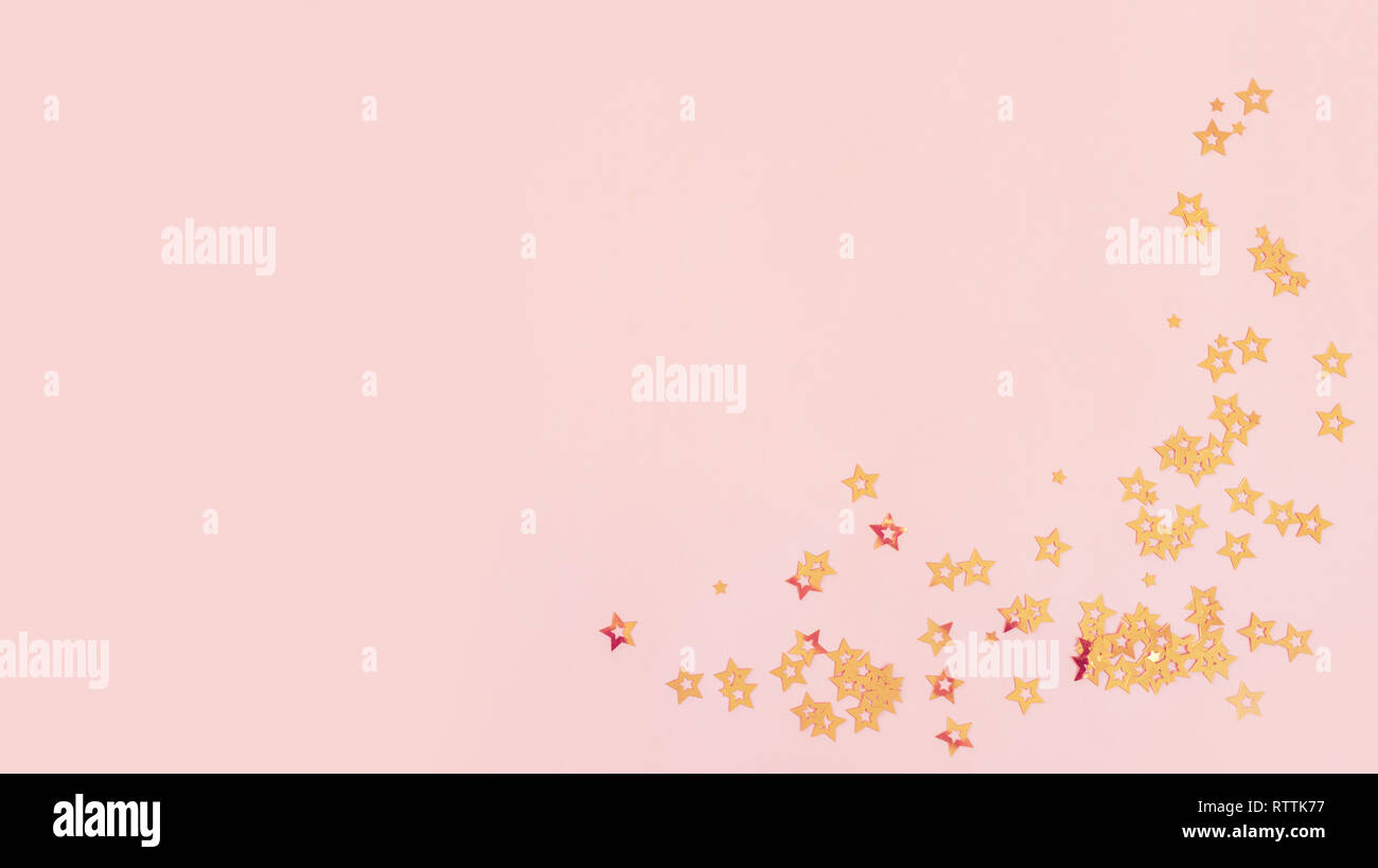 Pink background with stars, copy space. Golden stars confetti on pastel ...