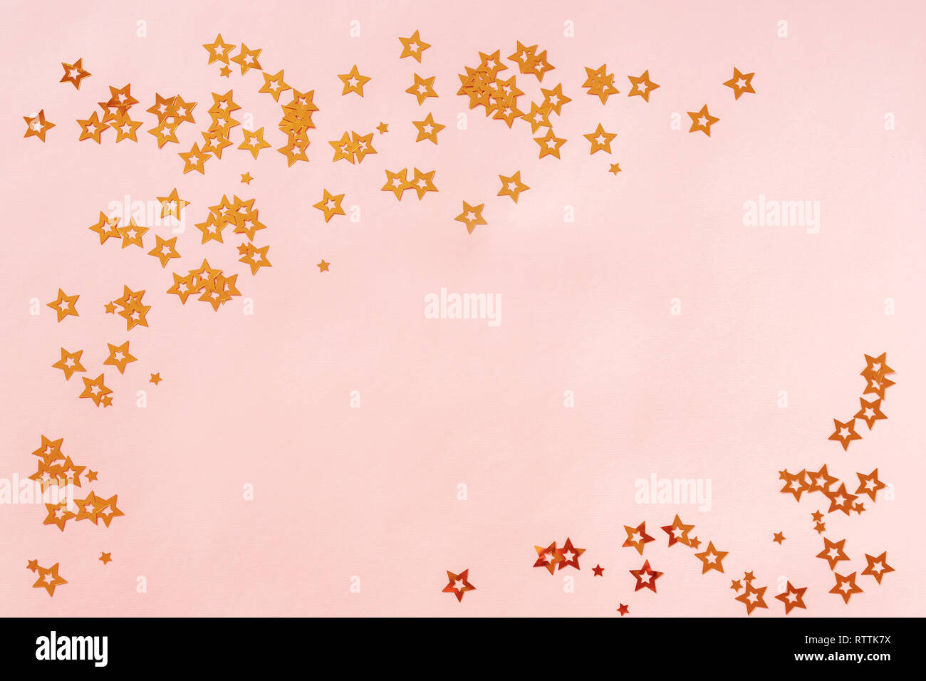 Pink background with stars, copy space. Golden stars confetti on pastel ...