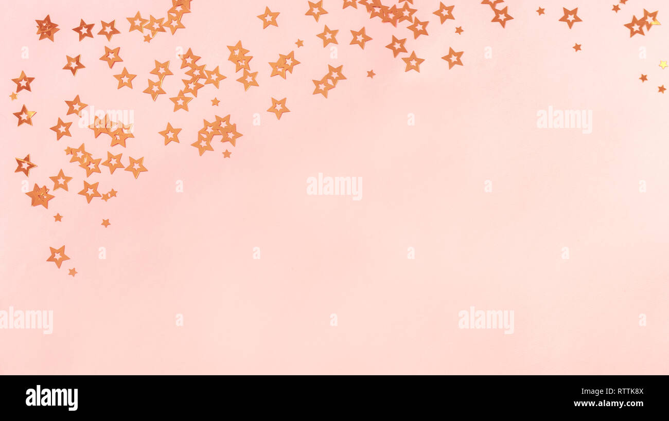 Pink background with stars, copy space. Golden stars confetti on pastel ...