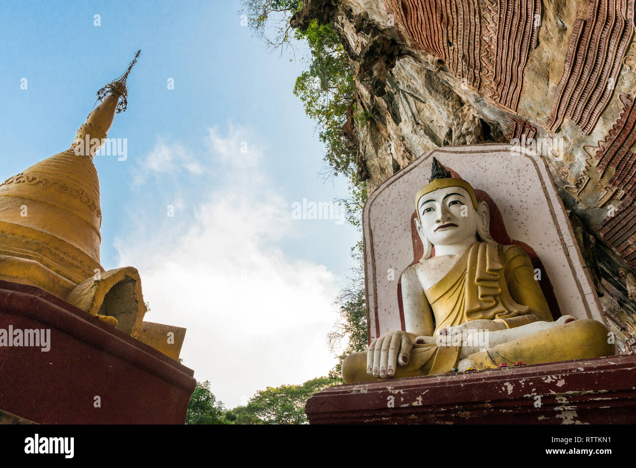 HPA-AN, MYANMAR - 19 NOVEMBER, 2018: Wide angle picture of golden pagoda and huge Buddha statue at Kaw Goon Cave in Hpa-An, Myanmar Stock Photo
