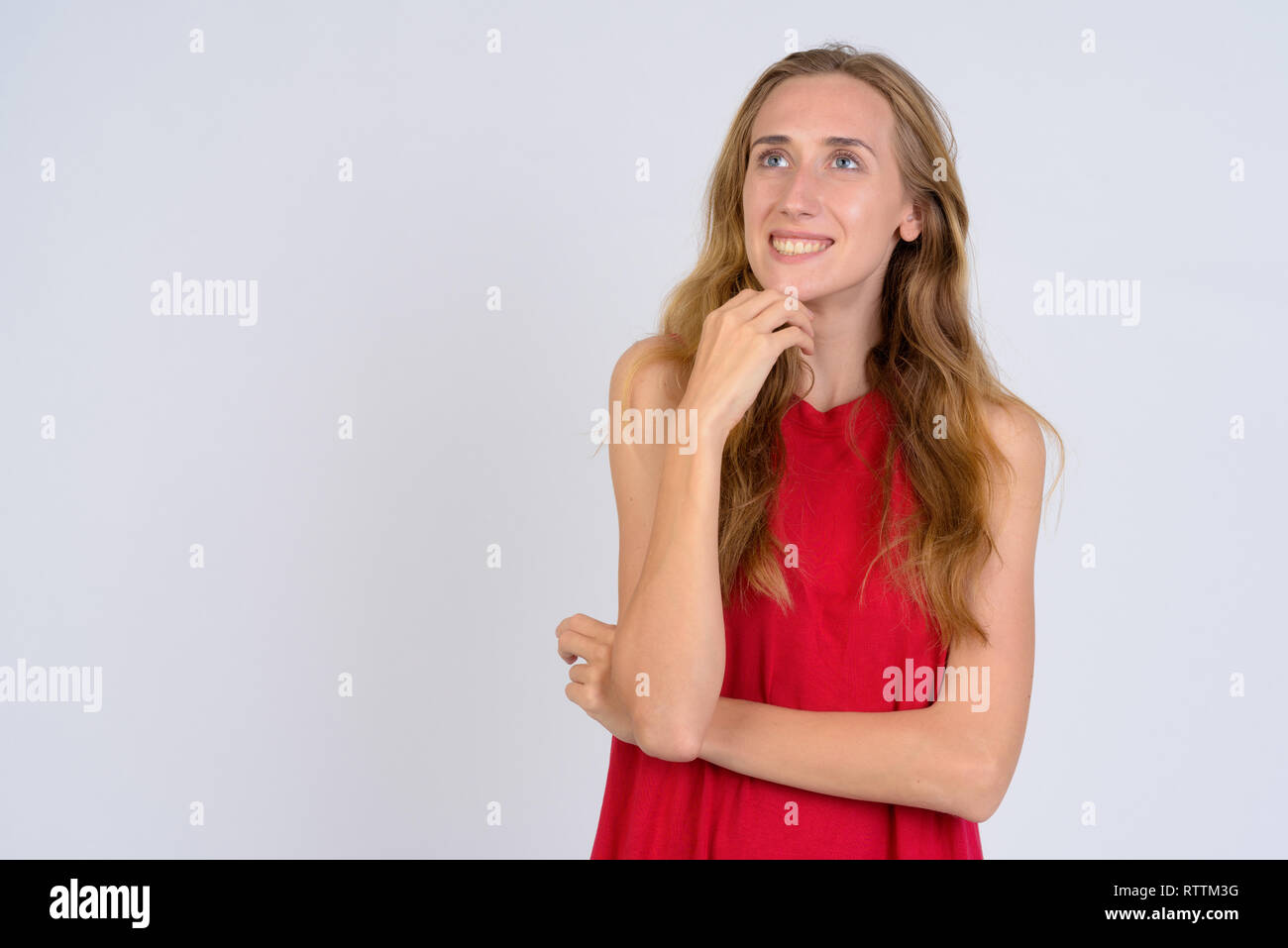 Portrait of young happy blonde woman thinking and looking up Stock ...