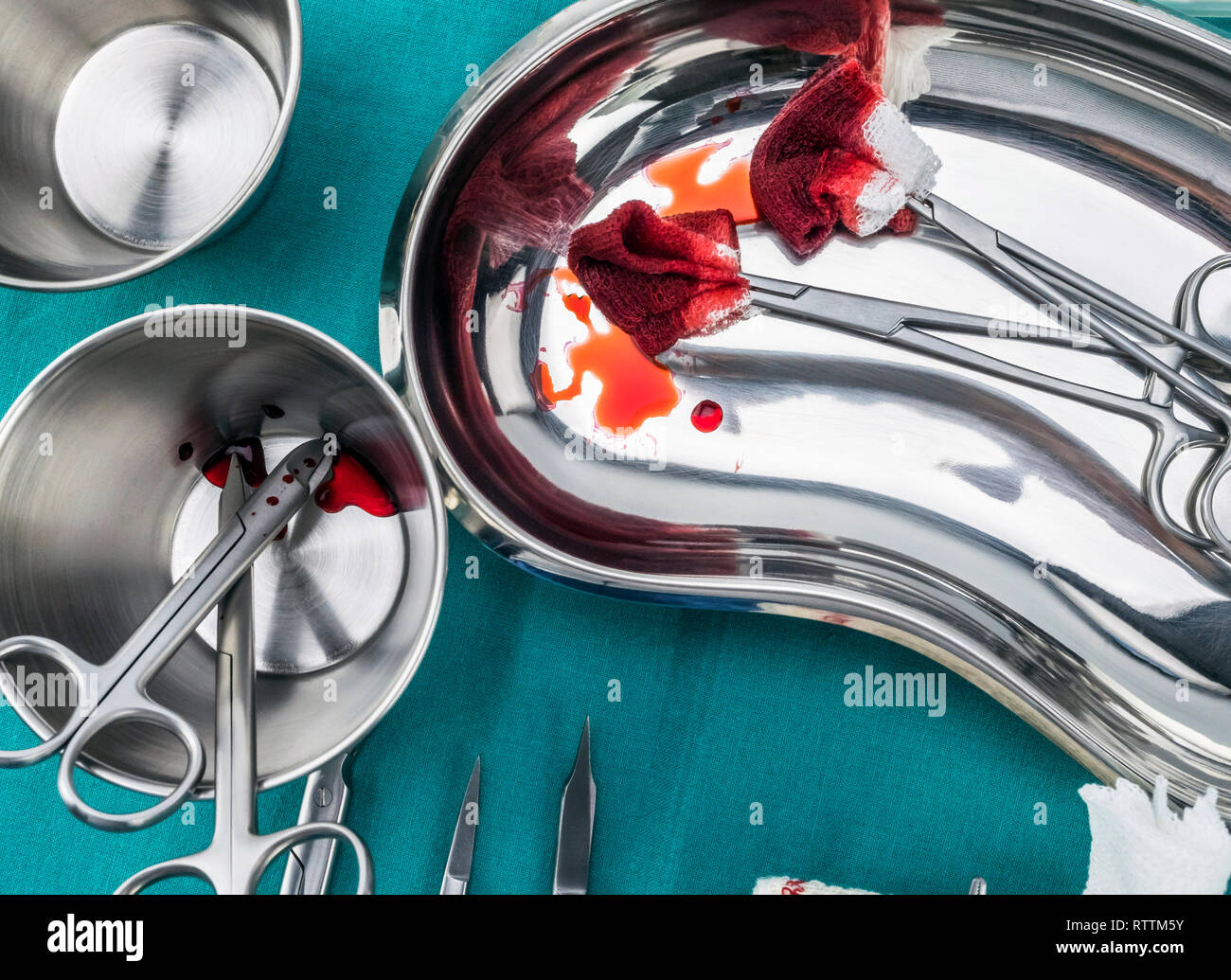 Scissors surgical with torundas soaked with blood on a tray metal in an ...