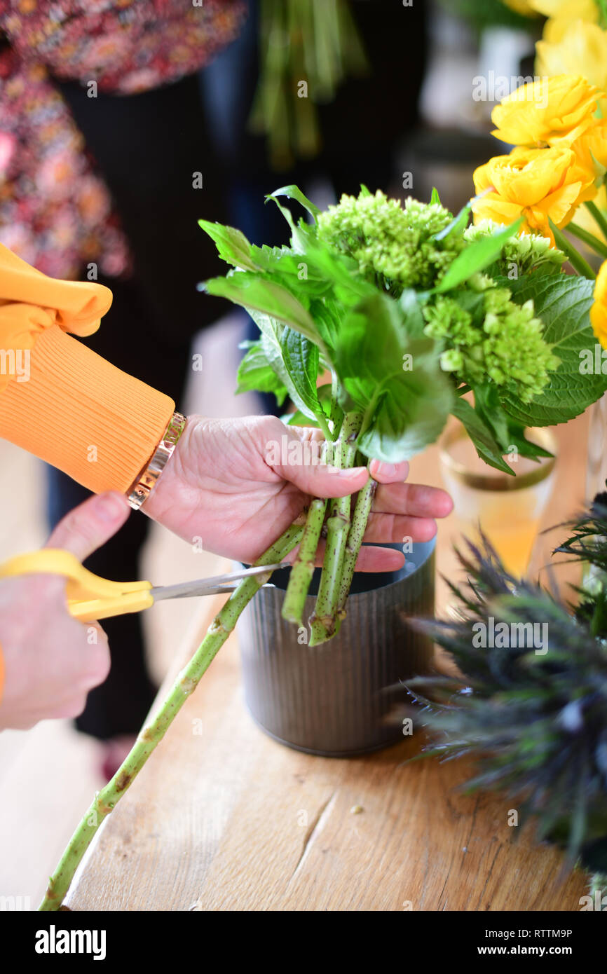 Making flower bouquets at floral arrangement party learning how to
