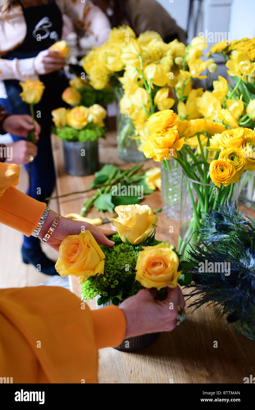 Making flower bouquets at floral arrangement party learning how to ...