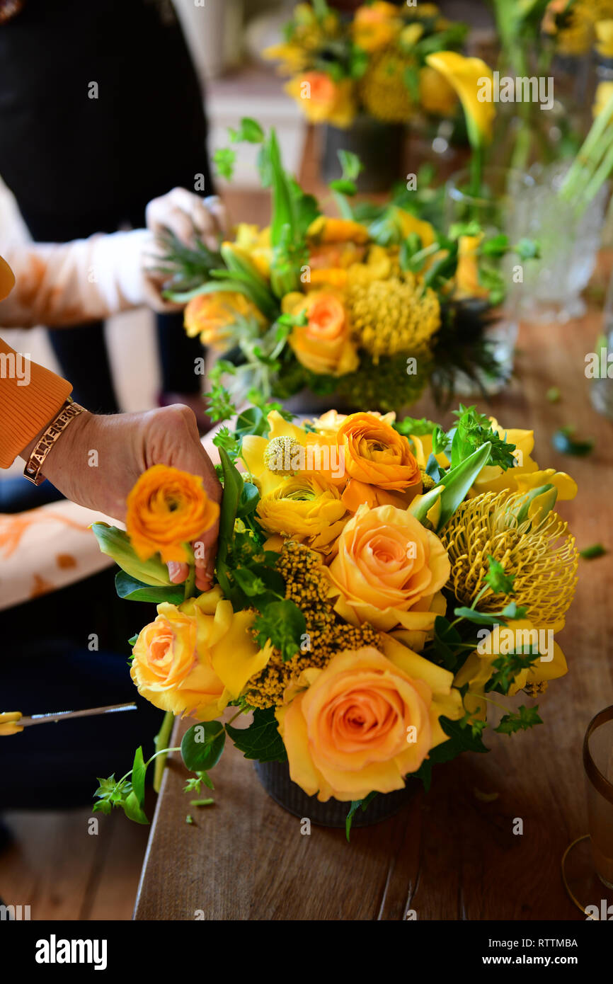 Making flower bouquets at floral arrangement party learning how to assemble flowers Stock Photo