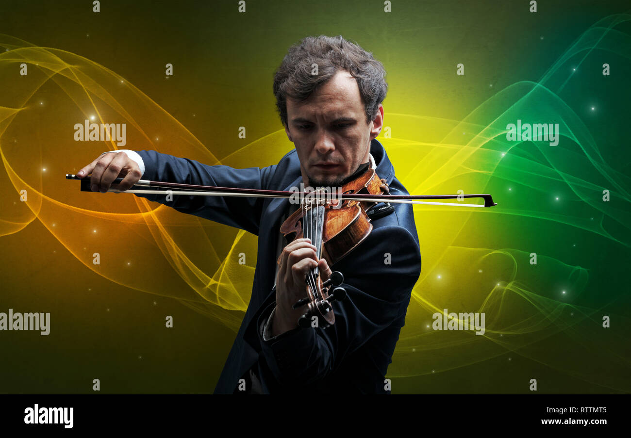 Serious classical violinist with fabled sparkling wallpaper Stock Photo
