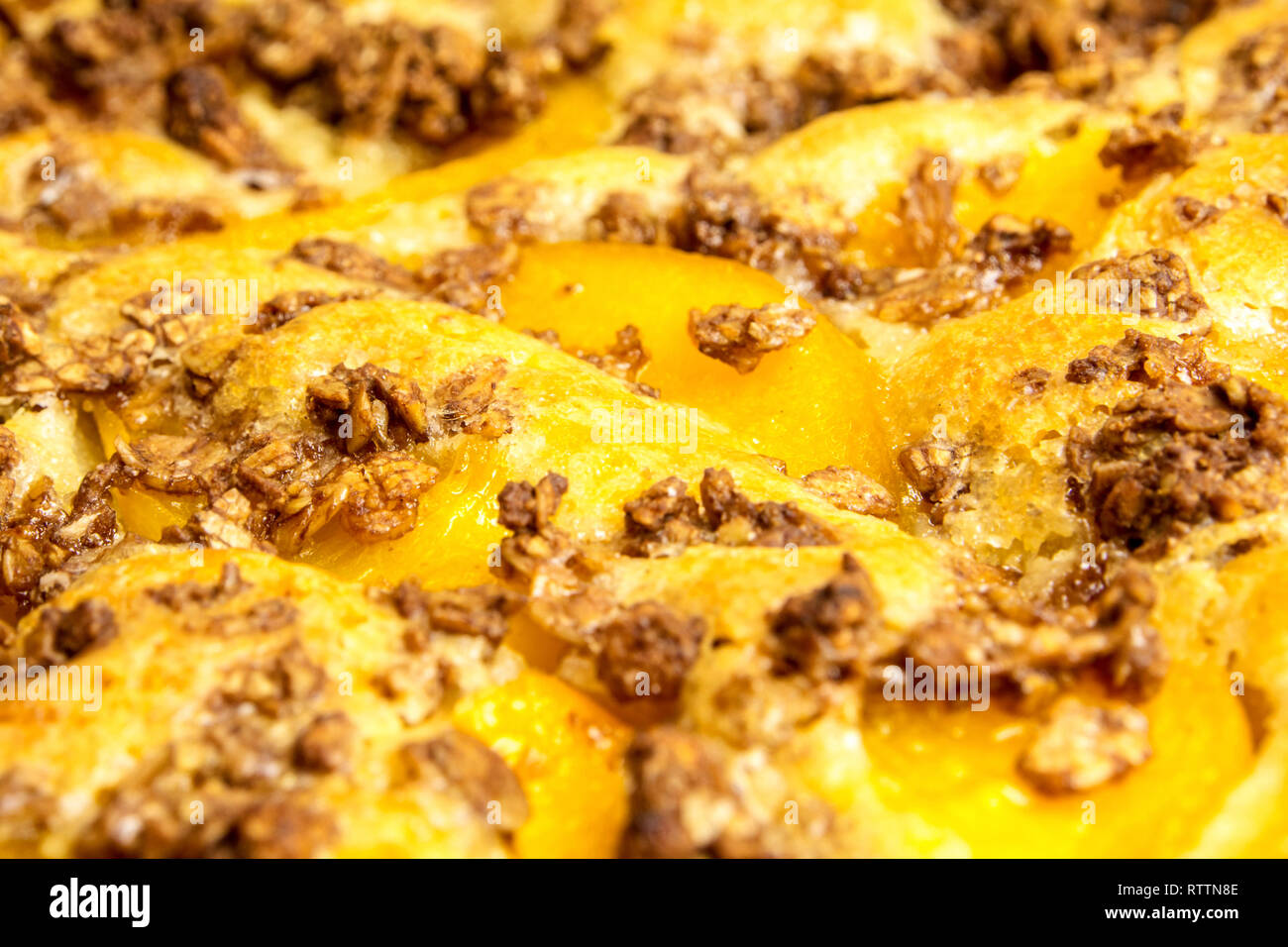 closeup of apple pie with oat flakes in violet fom on violet background Stock Photo