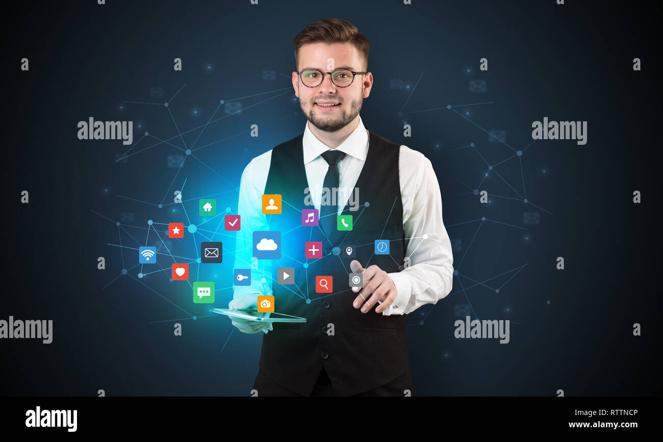 Handsome businessman in suit with tablet on his hand and application ...