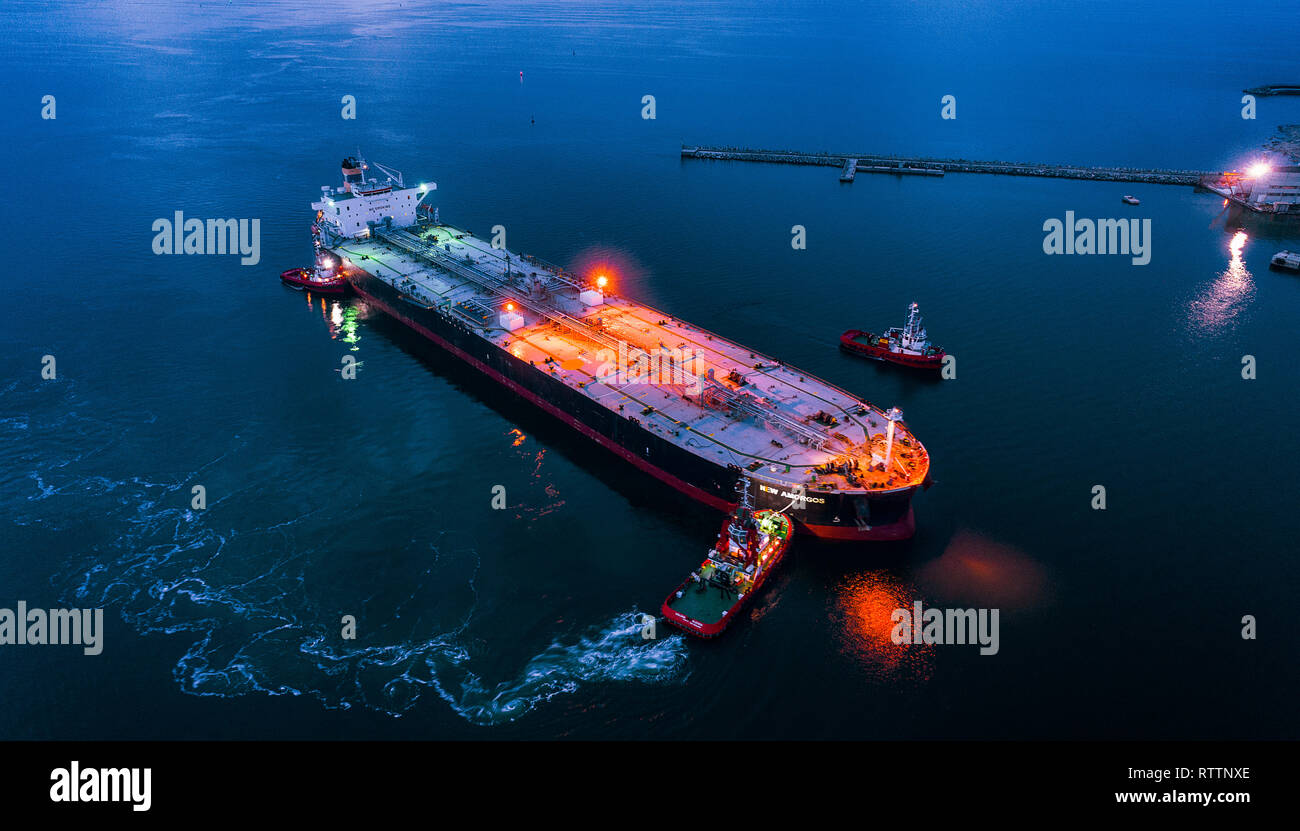 :Aerial view oil tanker ship at the port at night, import export business logistic and transportation. Stock Photo
