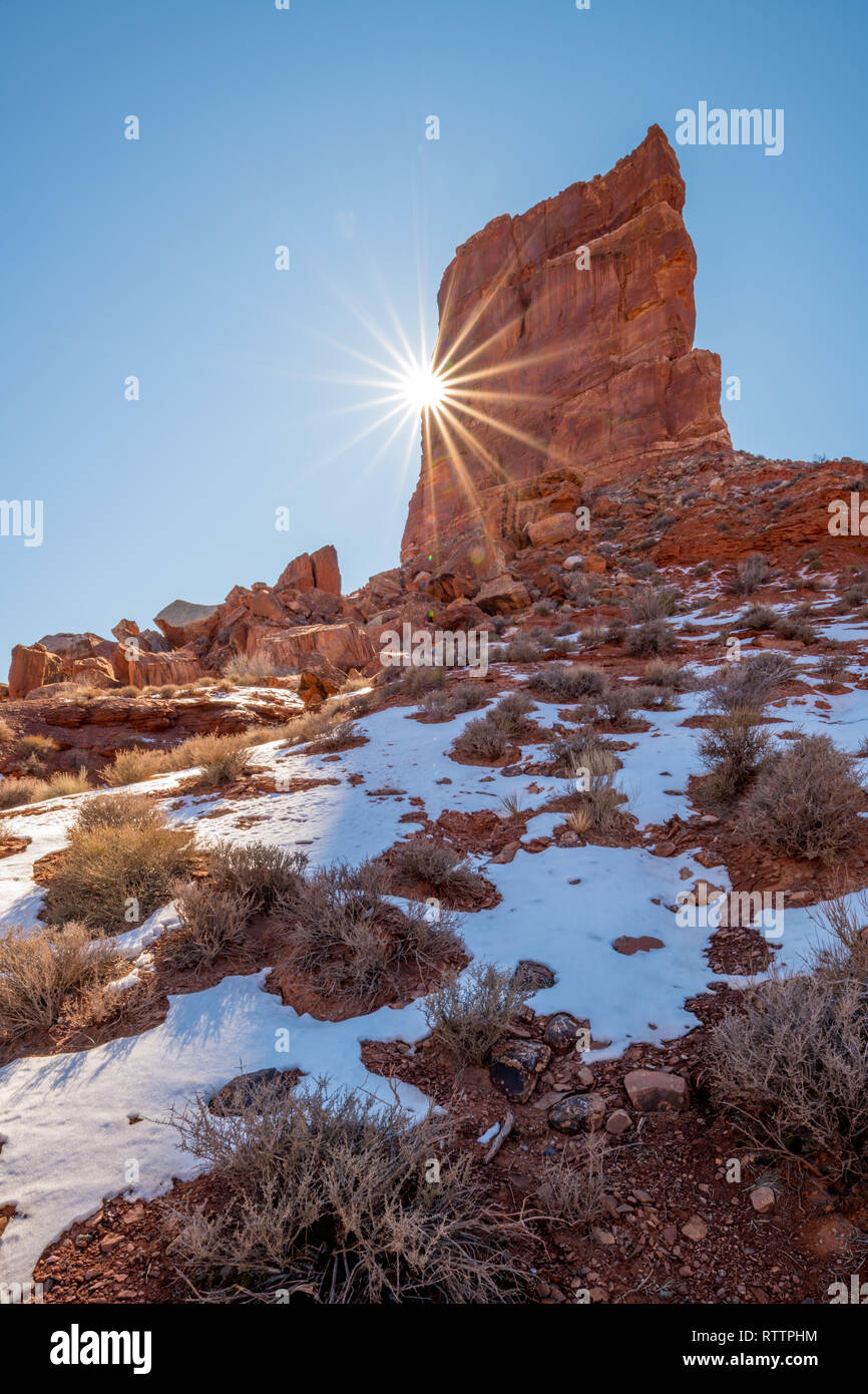 Snow Rocks Ground Winter snow on the ground below a rock peak with a sun star Stock Photo ...