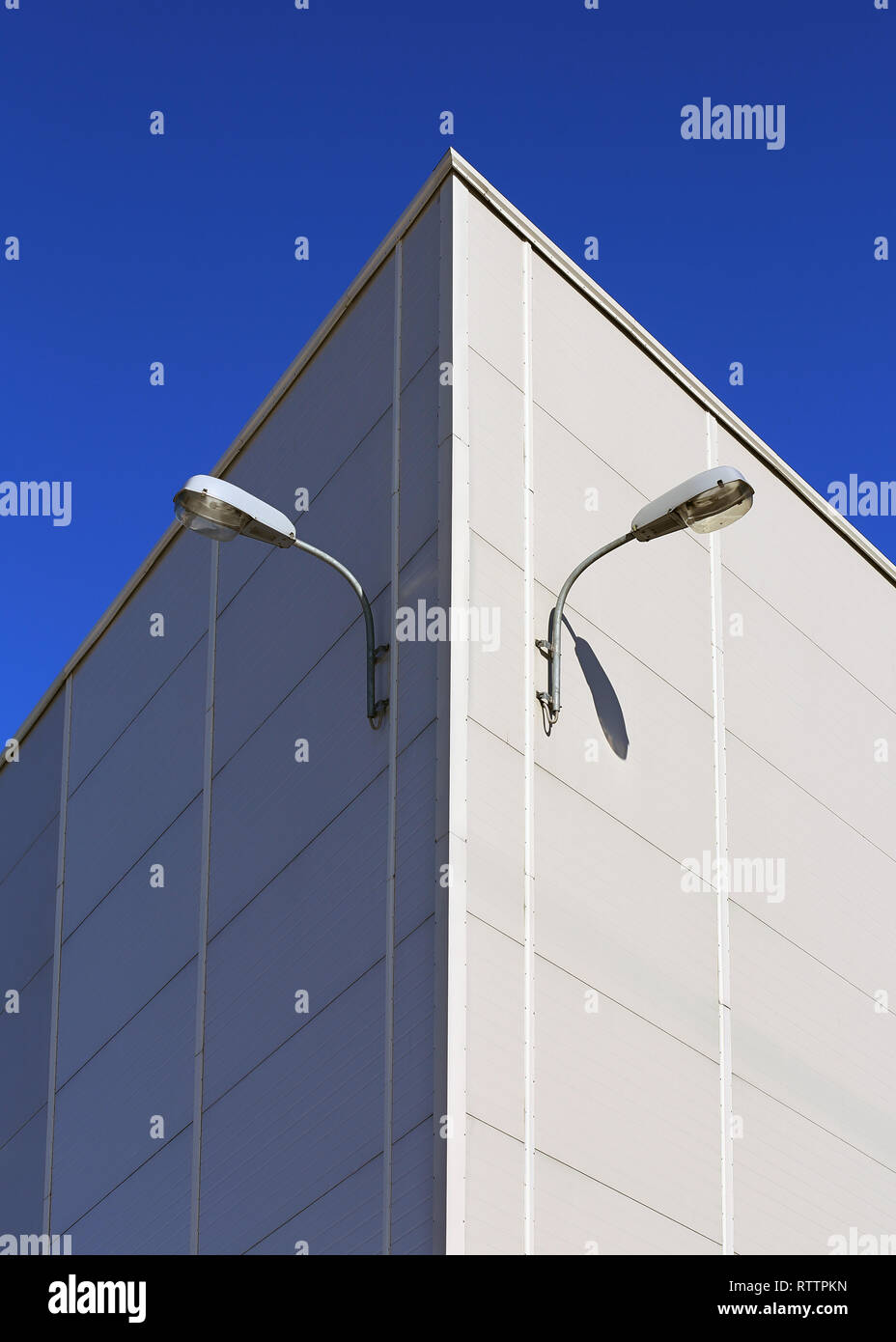 Two lamps on the outside wall of an industrial building Stock Photo