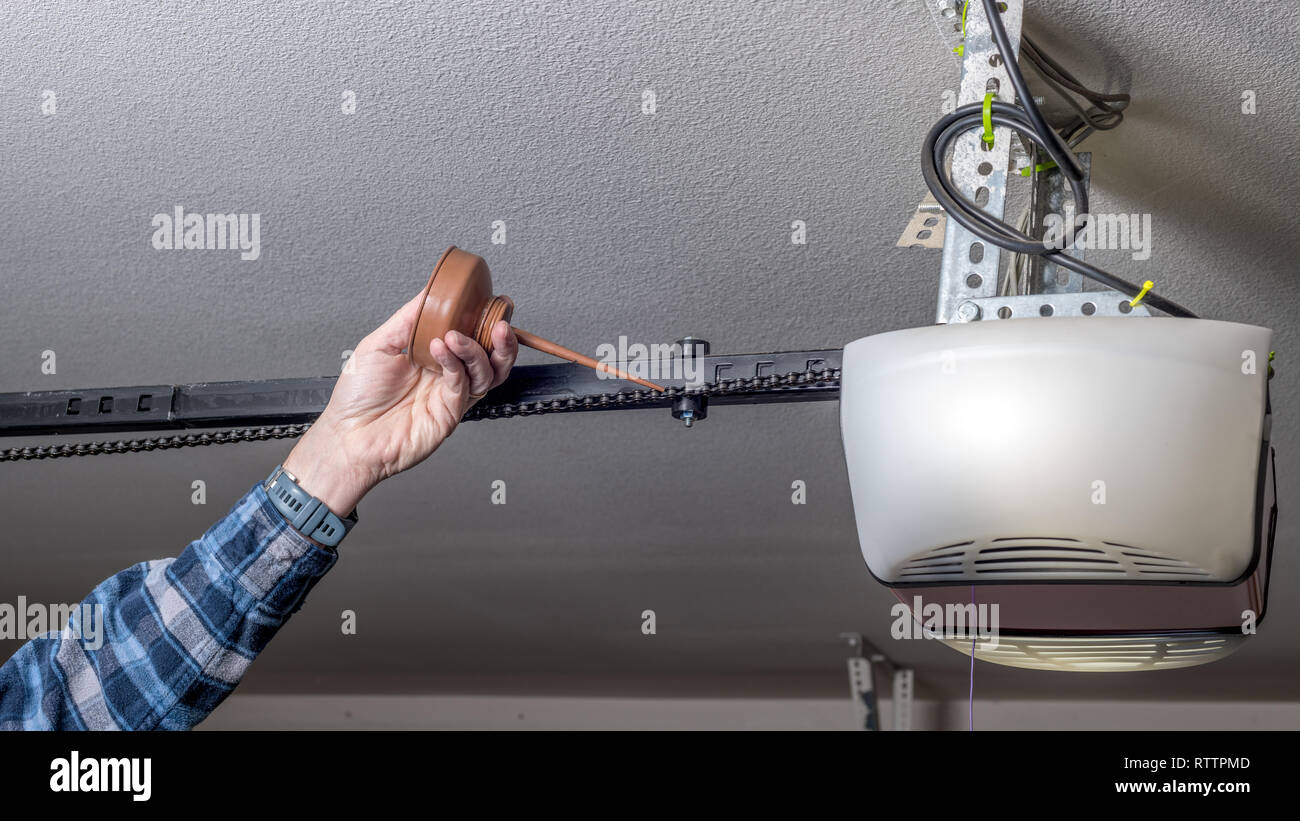 Maintenance of a garage door opener chain is to add oil today Stock
