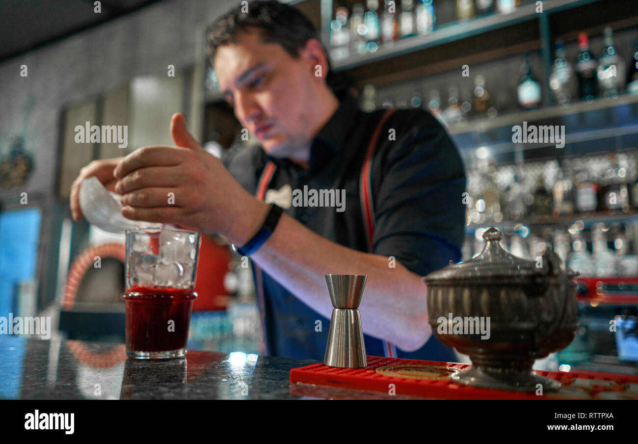 bartender pours a cocktail at the bar Stock Photo